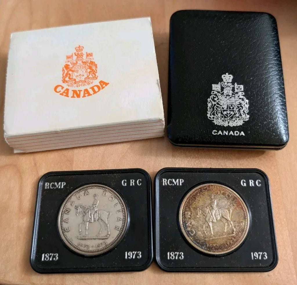 Two 1973 Cdn Silver Dollars - 1 Lightly Toned & 1 UNC - 100 years of RCMP - NumisFind